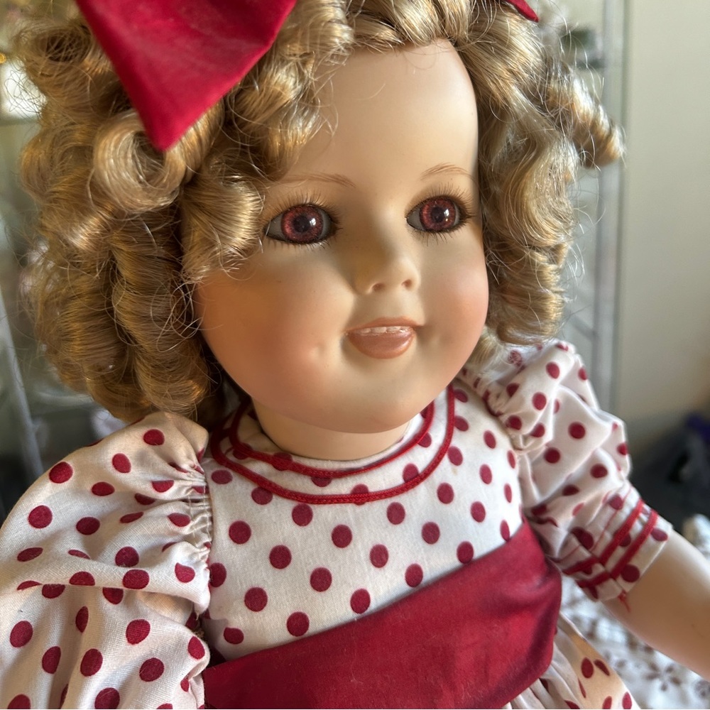 Shirly Temple full body porcelain doll. She is a reproduction doll.